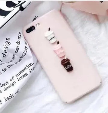 A soft pink silicone iPhone case featuring a raised 3D cartoon cat design on the back.