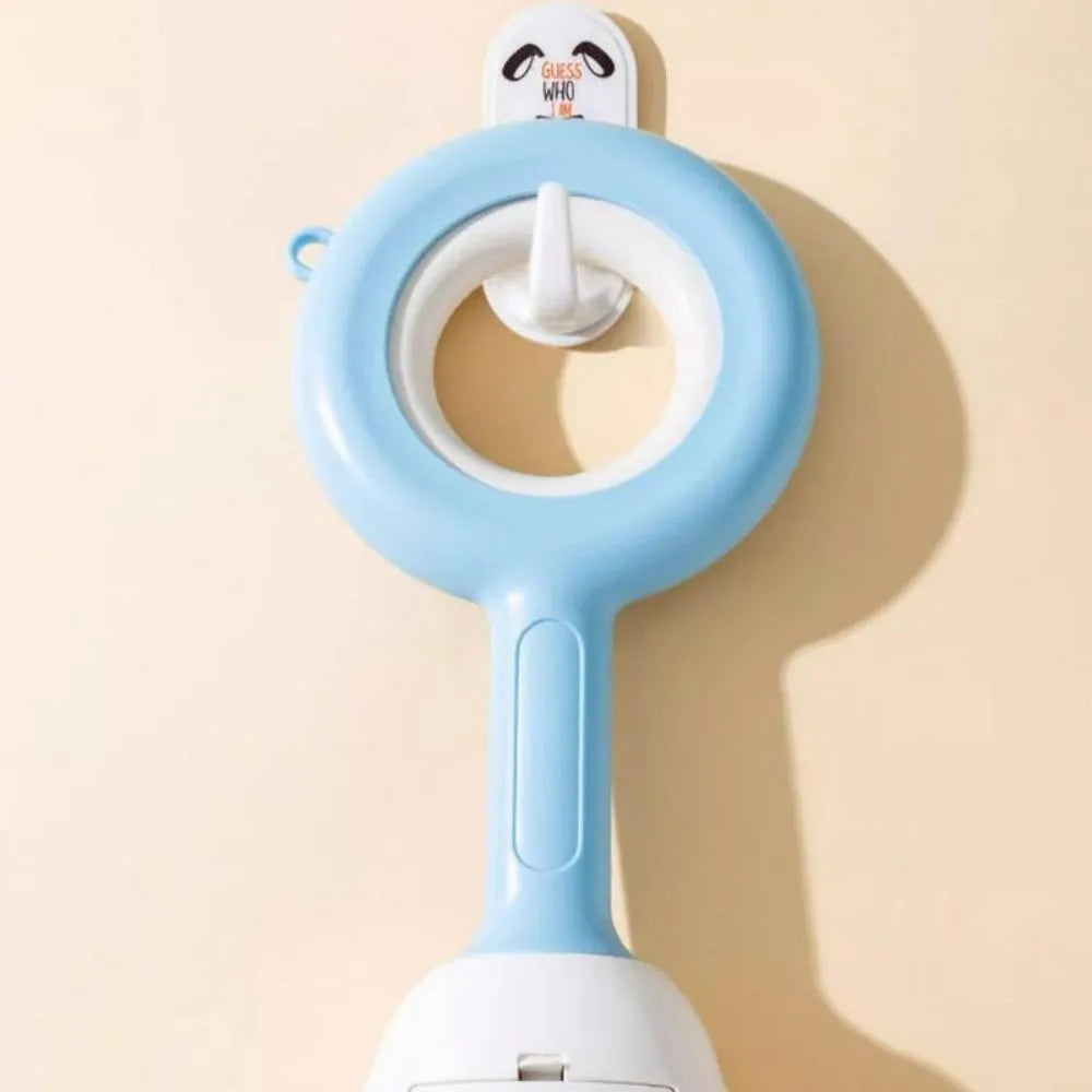 Blue cloud shape jaw dog pooper scooper on a lawn