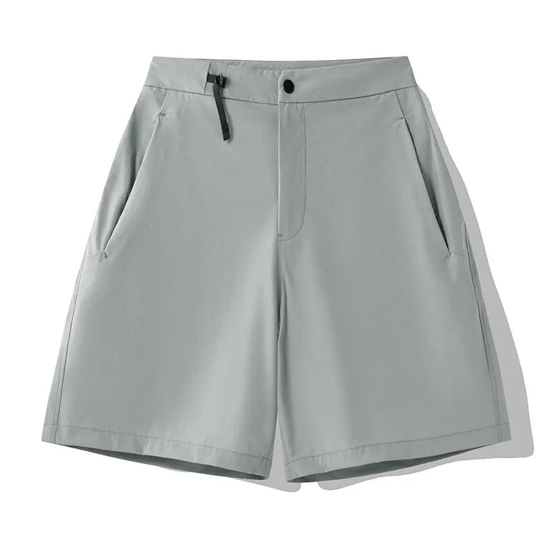 Men's solid colour quick-drying sports shorts with elastic waist on a neutral background.