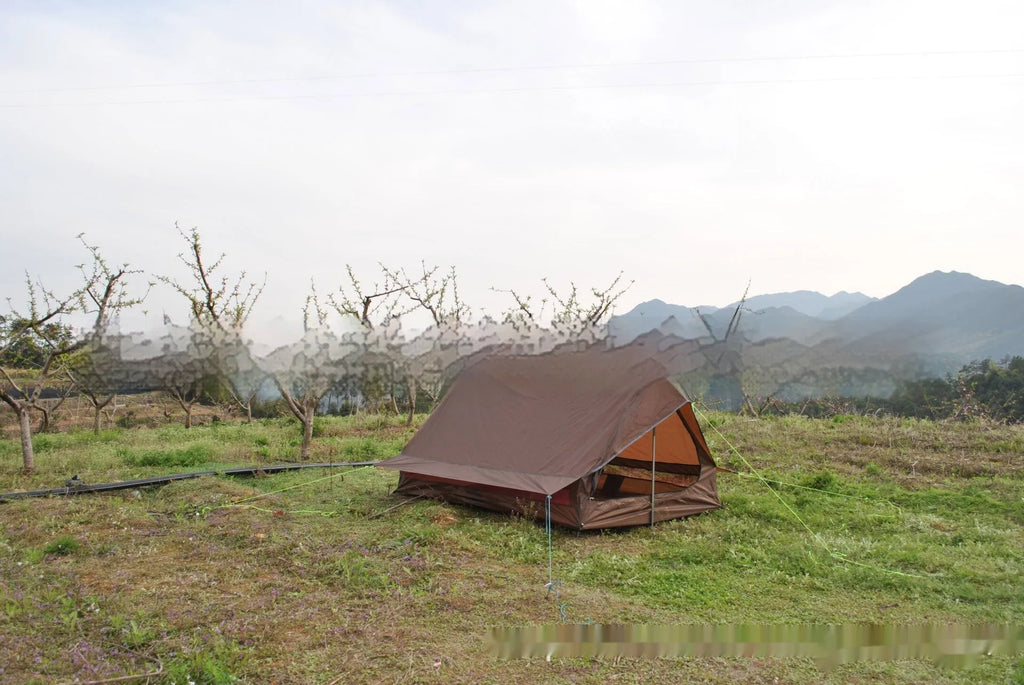 Brown or white A-frame pole-free cabin tent erected with hiking cane supports