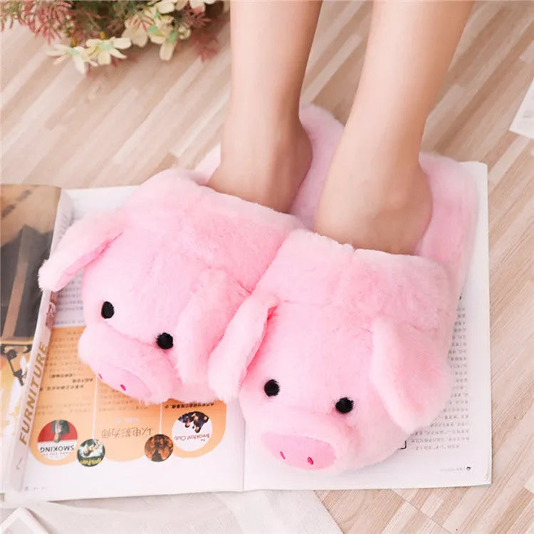 Pink pig-shaped floor slippers with short plush fabric on a plain background.
