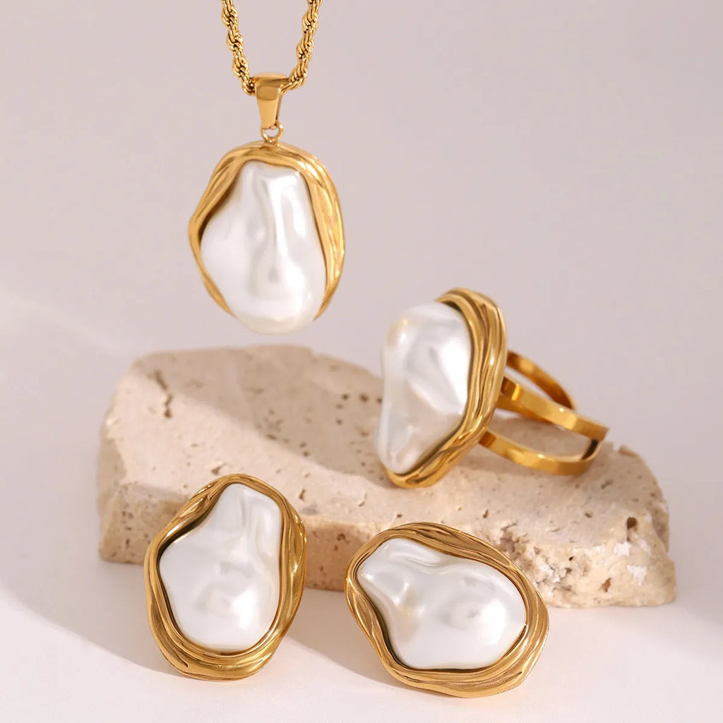Women's stainless steel necklace with irregular mother pearl shellfish pendant on regular chain, with matching earrings and ring