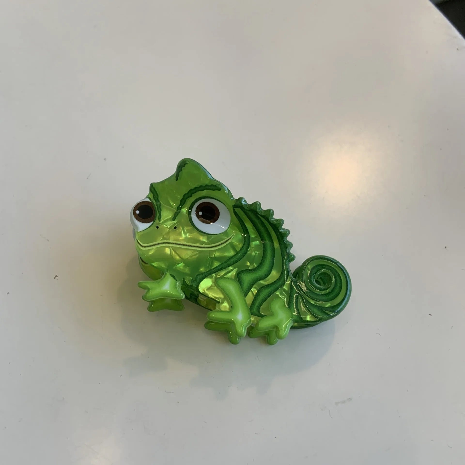 Dinosaur-themed acrylic jaw hair clip showing six colour variations with grip mechanism