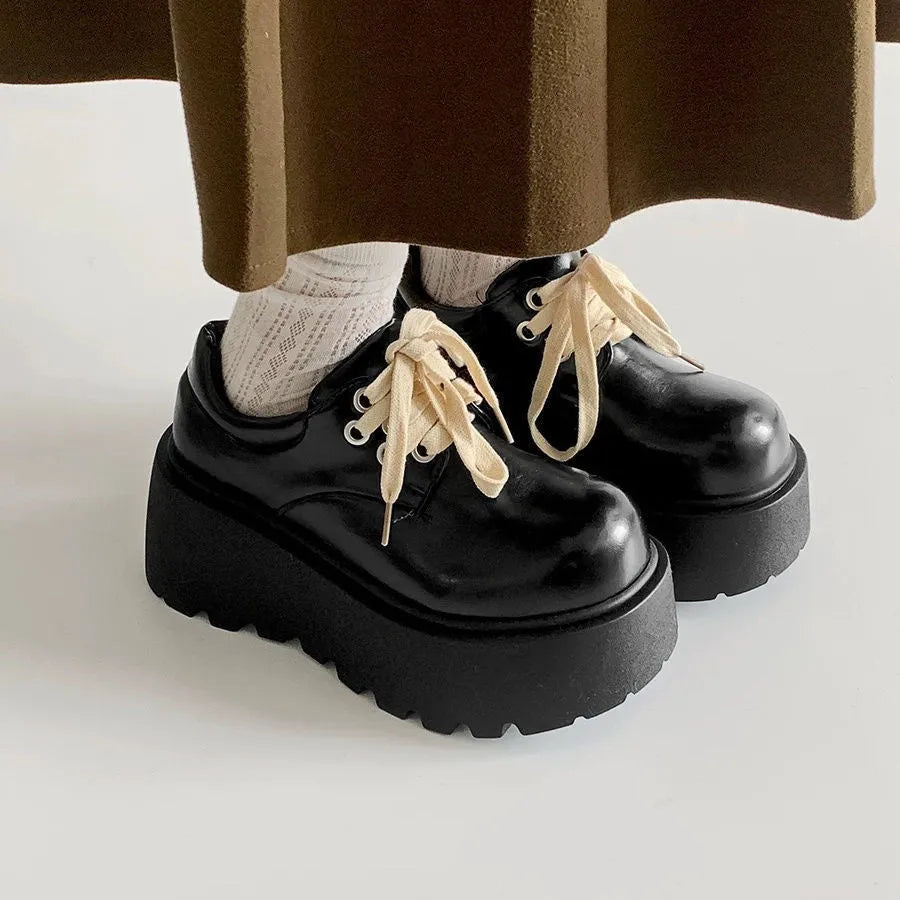 Women's matte black retro chunky sole lace-up ankle boots with a round toe on a white background.