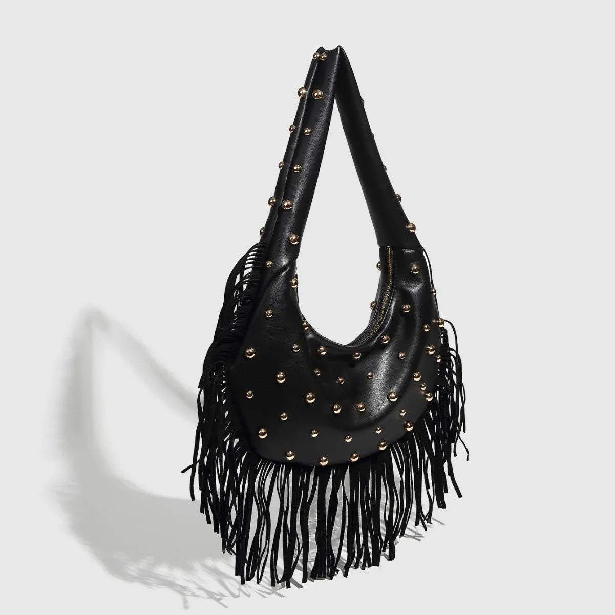 Retro black tassel shoulder handbag showing internal mobile phone pocket and decorative tassel detail.