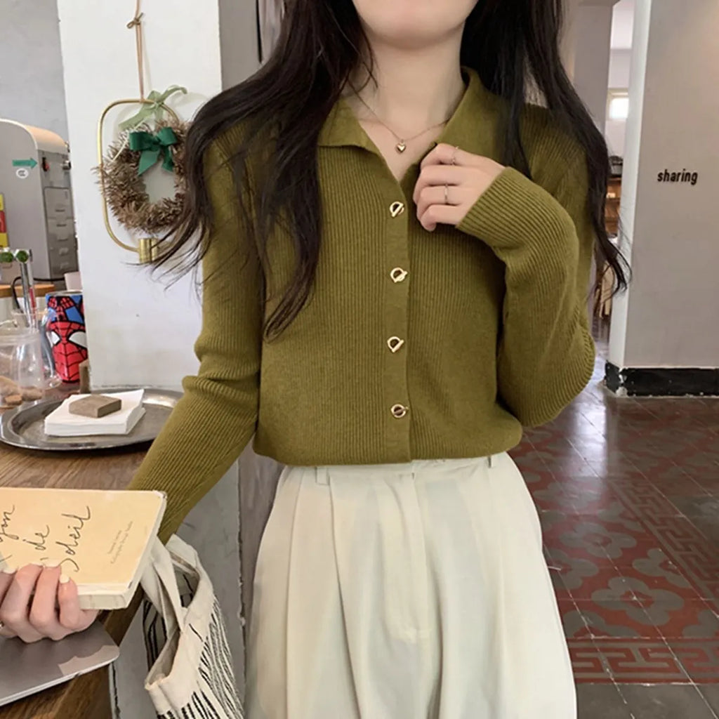 Beige loose fit long-sleeved viscose knitted cardigan top on a hanger.