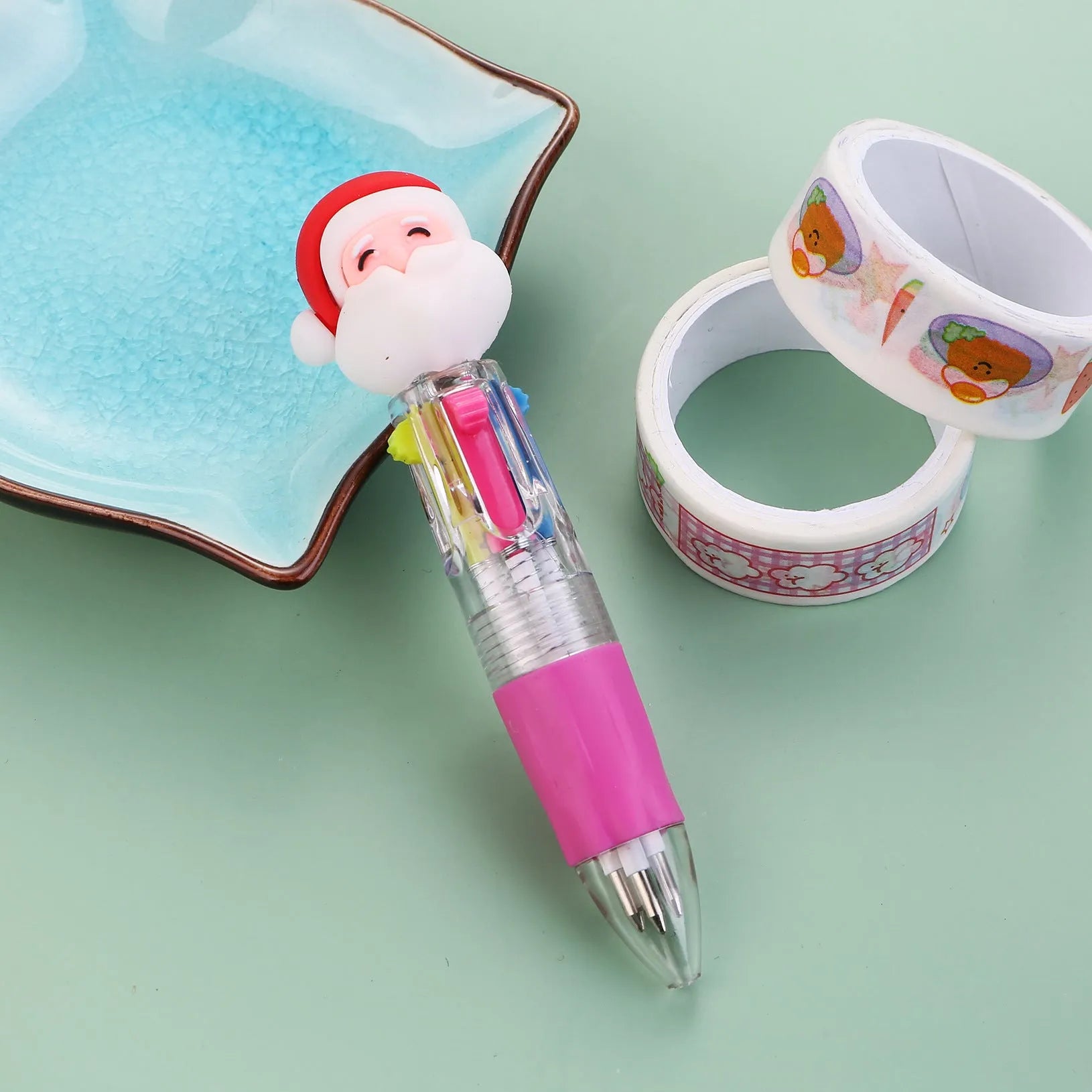 Christmas mini four-colour press-type ballpoint pen showing festive designs, 11cm long.