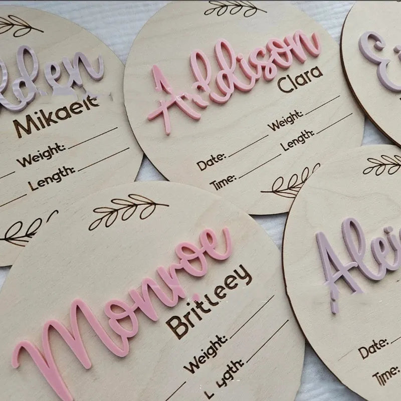 Square wooden baby name sign with birth information, 15 cm wide, in one of three style variants.