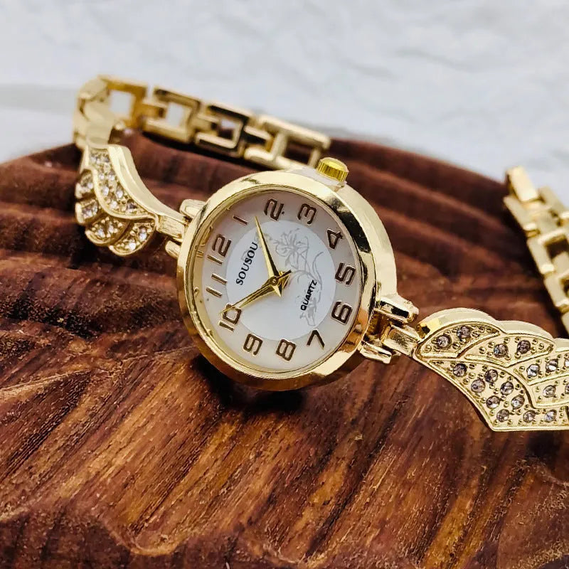 Women's stainless steel watch with round dial showing gold face colour option