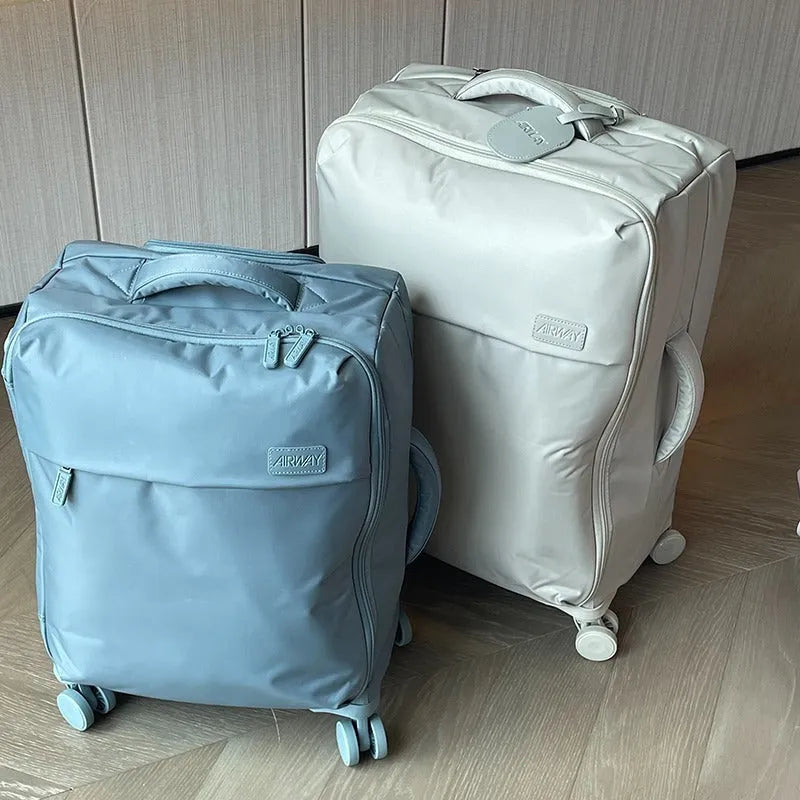 Ultra-light waterproof Oxford cloth suitcase in bluestone green with universal wheels, shown in a 24-inch size.