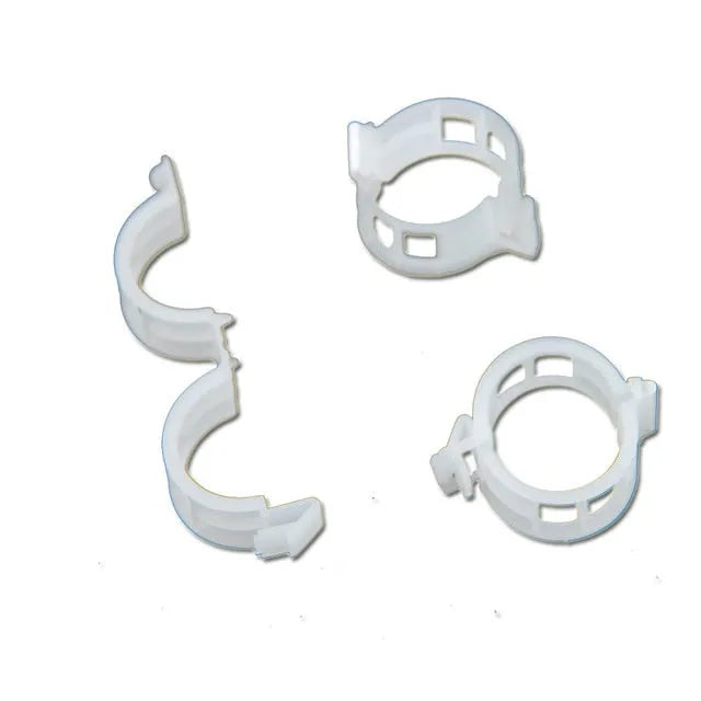 Set of 50 green and blue plastic grafting clips for supporting tomato plants and tree branches.