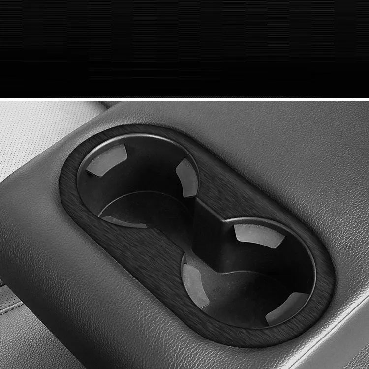 Car interior decorative film sticker kit showing carbon fibre pattern applied to centre console and dashboard