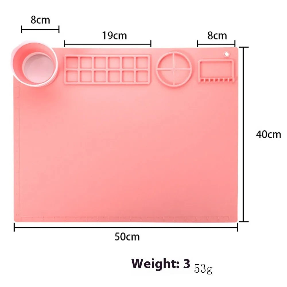 Light blue silicone painting mat with two integrated bowls for paint mixing, measuring 50cm by 40cm.