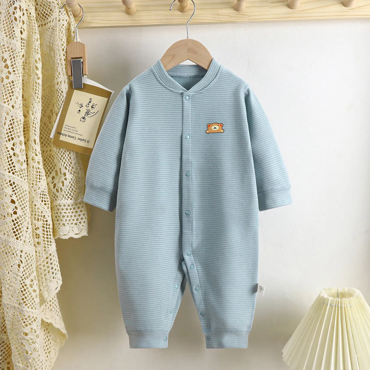 Baby Dralon striped jumpsuit romper in bean green with long sleeves and hide hook closure on white background