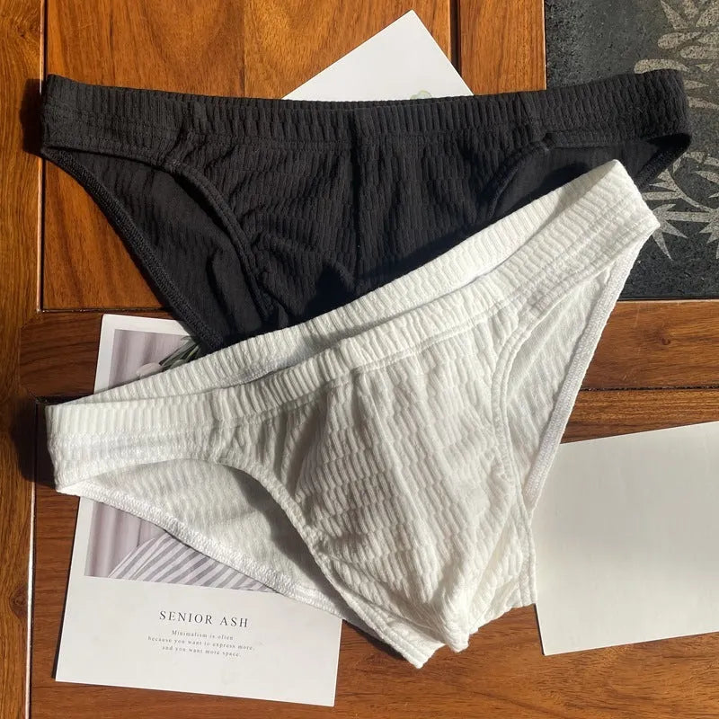 Men's solid colour cotton triangle underwear briefs on a mid-waist, shown in a skin tone colour.