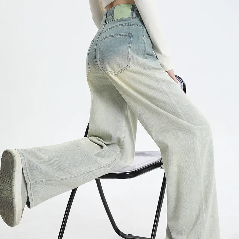 Women's gradient blue denim straight-leg wide-leg trousers laid flat, showing colour fade.