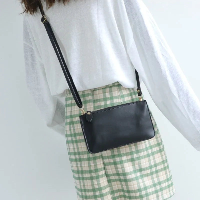 Mini touch screen phone bag in cross square shape with soft surface material, blue colour, and zippered pockets