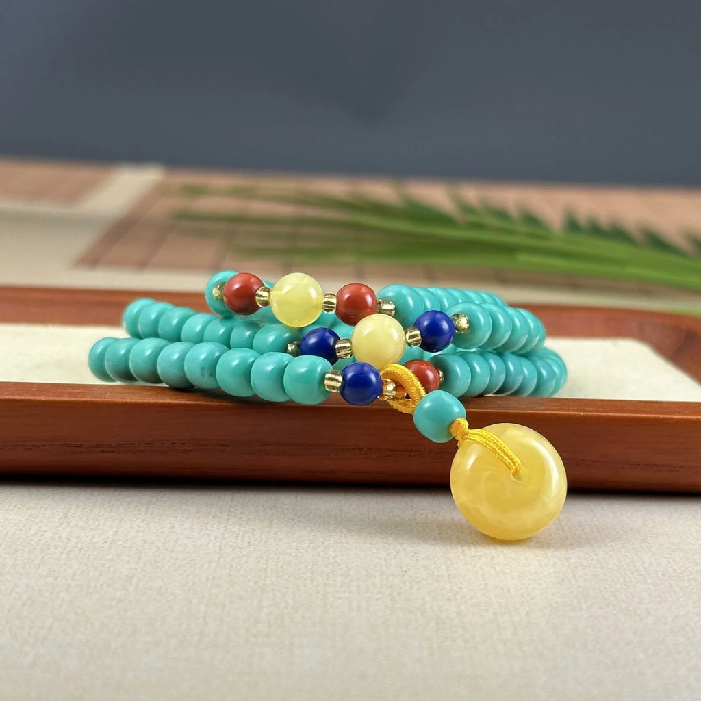 Turquoise lucky pendant necklace with hand-woven mesh flower stone design on a ball bead chain.
