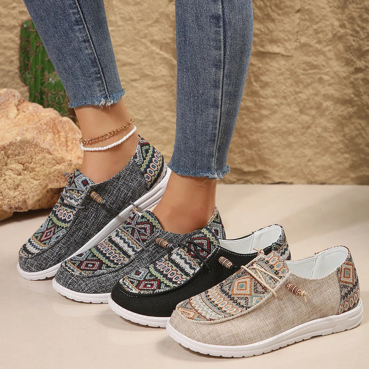 Women's black flat slip-on shoes with round toe and rubber sole on a neutral background.