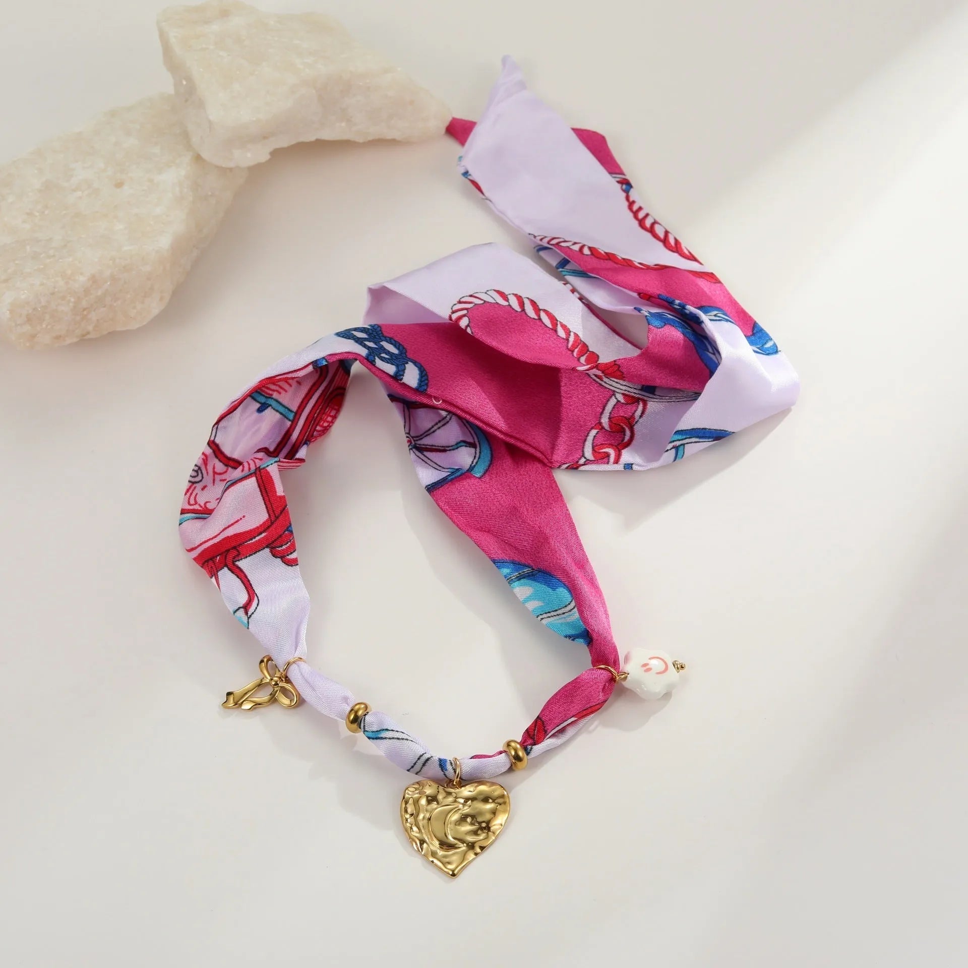 Gold geometric love pendant necklace and matching bracelet set on a white background