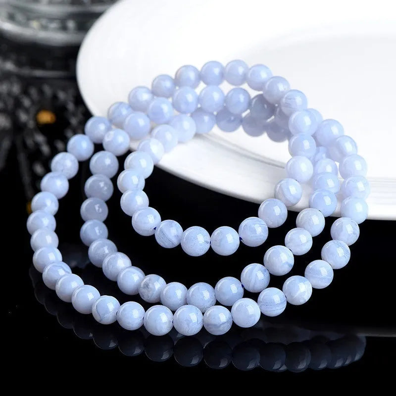 Blue agate bracelet with striped patterns showing 6-6.8mm beads and natural stone colour variations