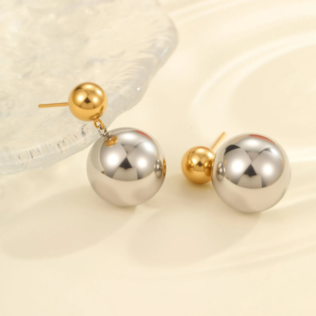 A pair of geometric round bead ear studs with a colour-block finish on stainless steel.