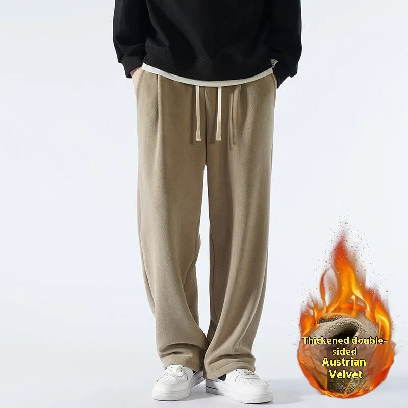 Men's apricot coloured loose-fit polar fleece trousers with a drawstring waistband, shown laid flat.