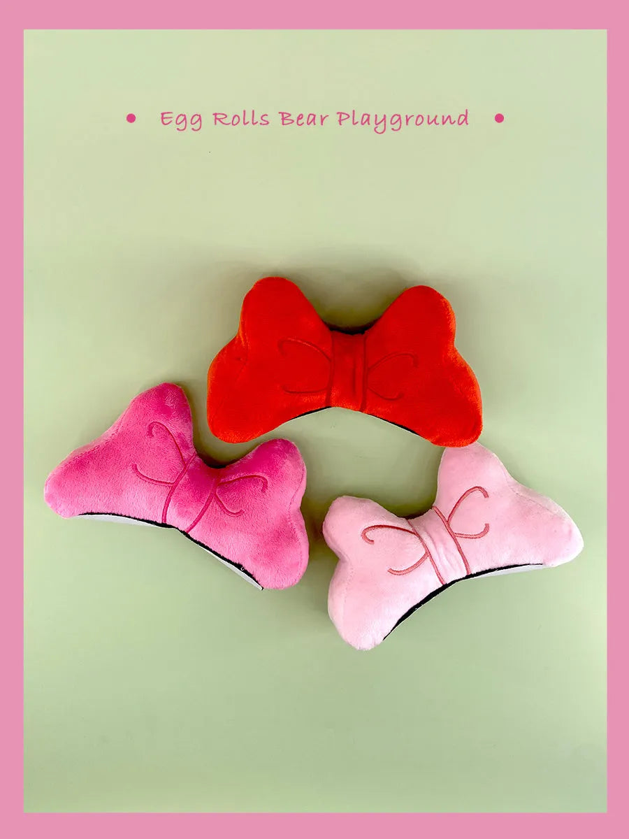 Soft plush bow helmet decoration for motorcycle and ski helmets in red or pink colours.