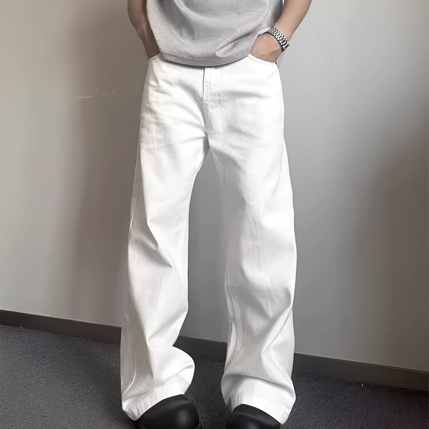 A pair of men's straight-leg white jeans with a mid-rise waist and zipper fly on a plain background.