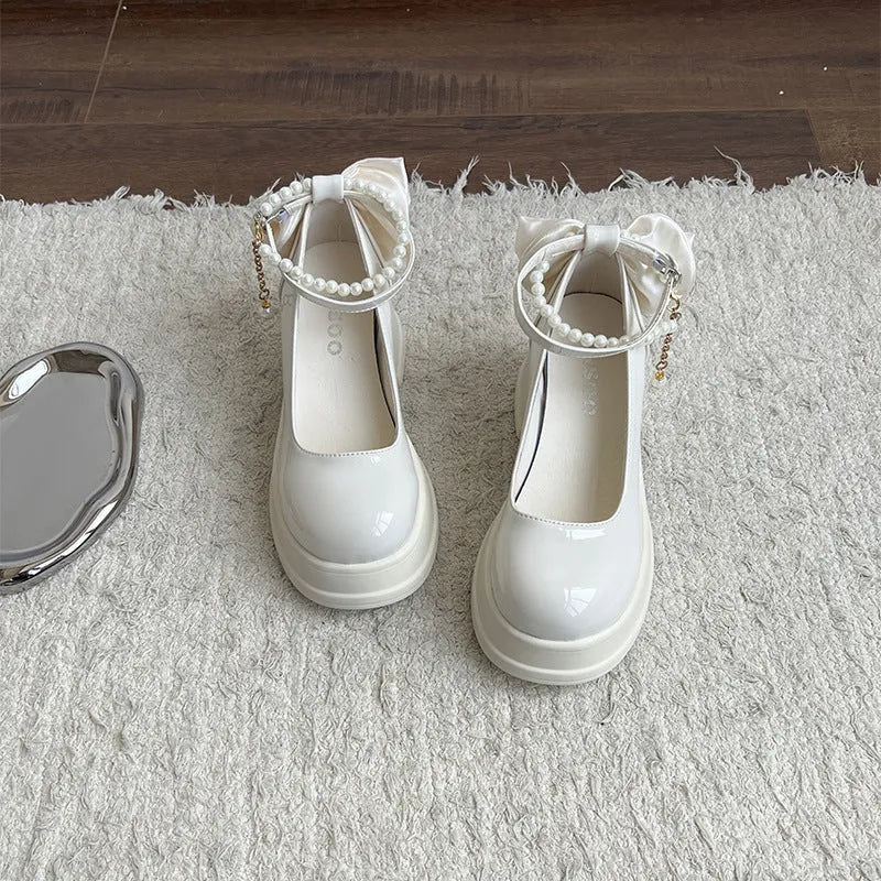 Beige and black women's Mary Jane pumps with a round toe and chunky heel.