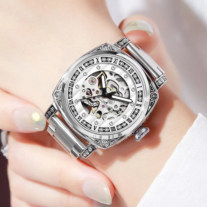 Mechanical watch with luminous numerals on a leather strap, shown in multiple colour options.