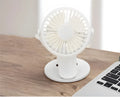 White USB clip fan with plastic blades attached to desk edge showing piano button controls