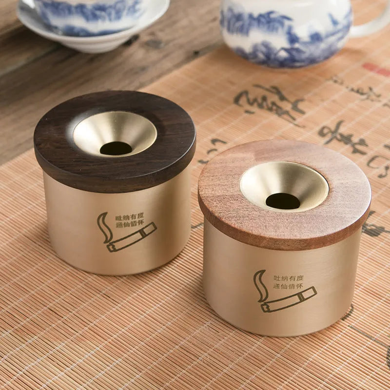 Retro brass-coloured copper ashtray with a wooden lid featuring a central hole