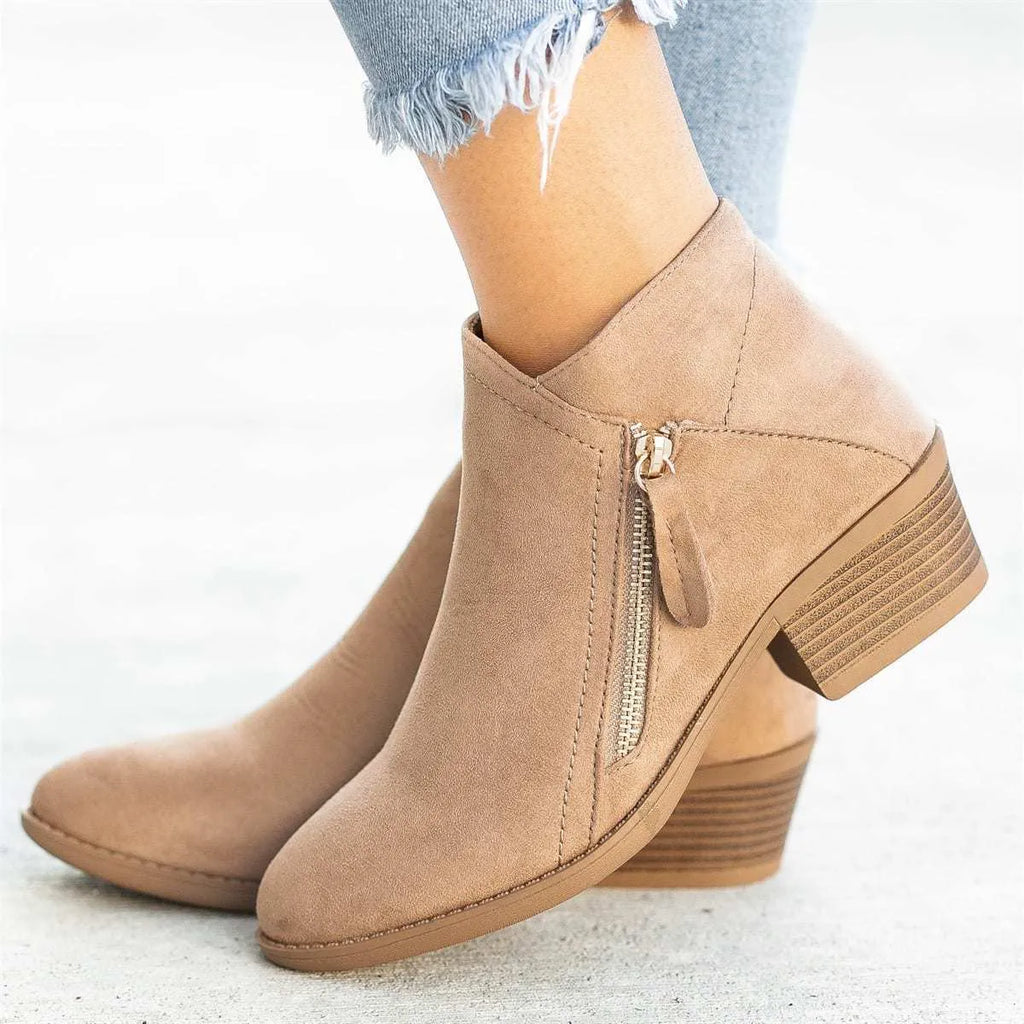 Blue suede women's ankle boots with a side zip and chunky composite sole, shown from the side.