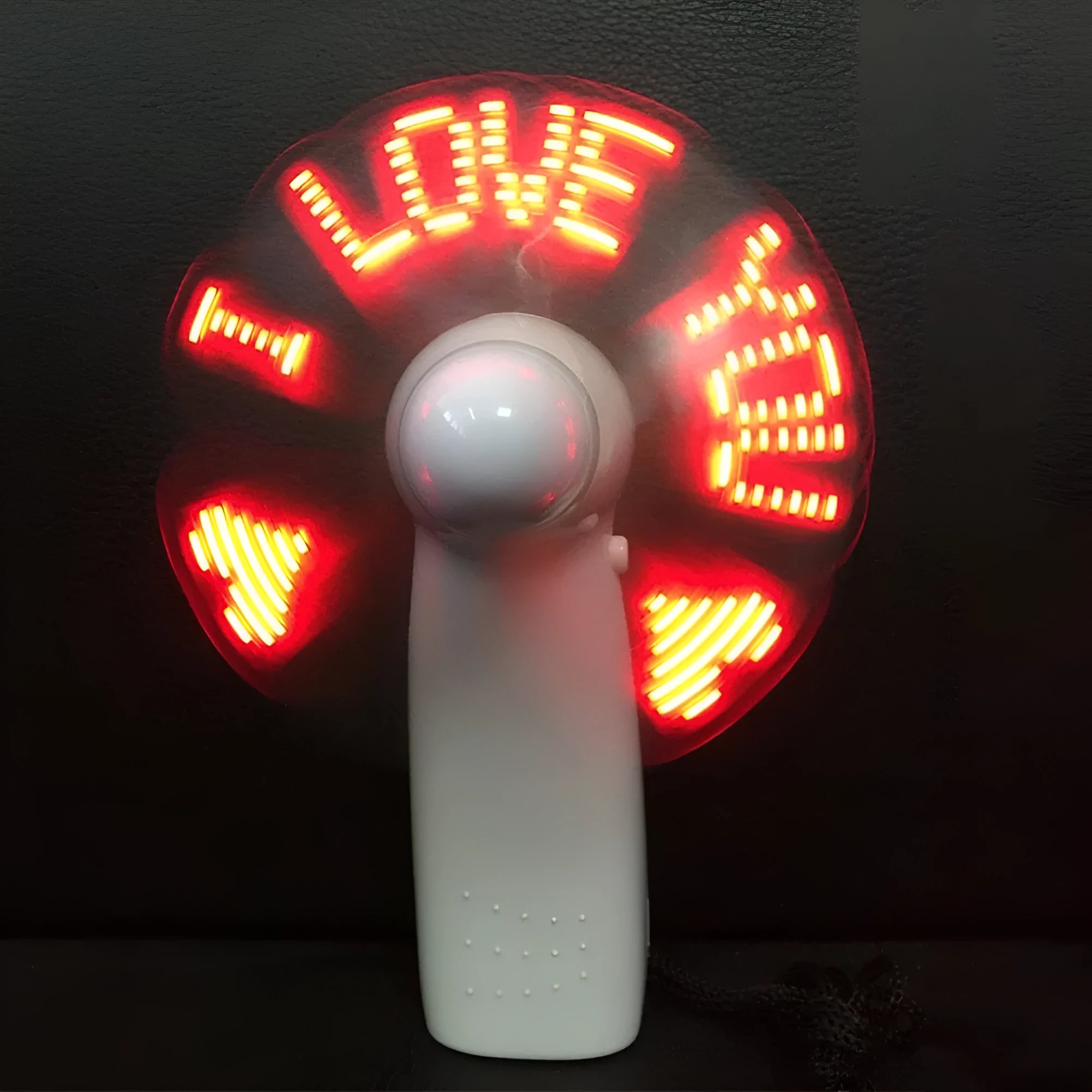 White handheld fan with LED lights displaying I Love You pattern in blue and red colours