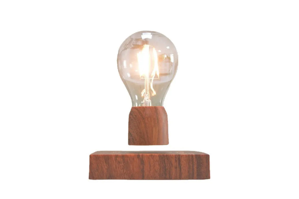 Magnetic levitation light bulb with imitation wood base on table.