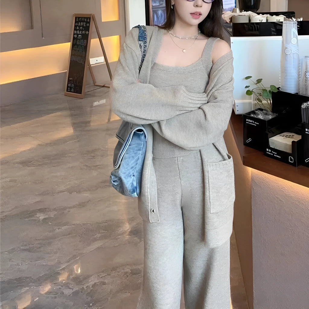 Women's light brown knit cardigan three-piece set with suspender casual pants on a hanger.