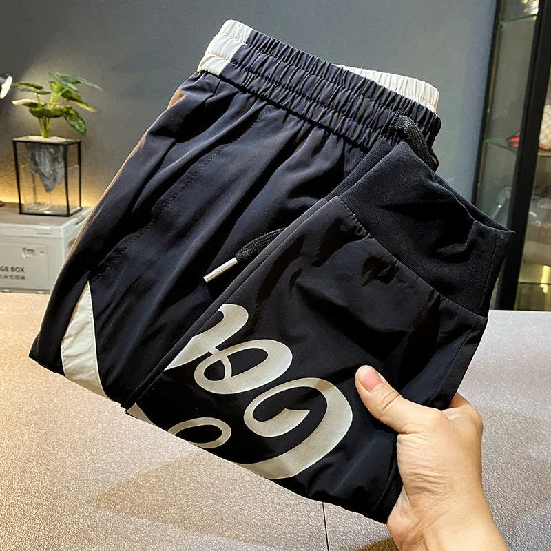 Black men's casual cropped trousers with banded ankle, made from ultra-thin ice silk cotton fabric.