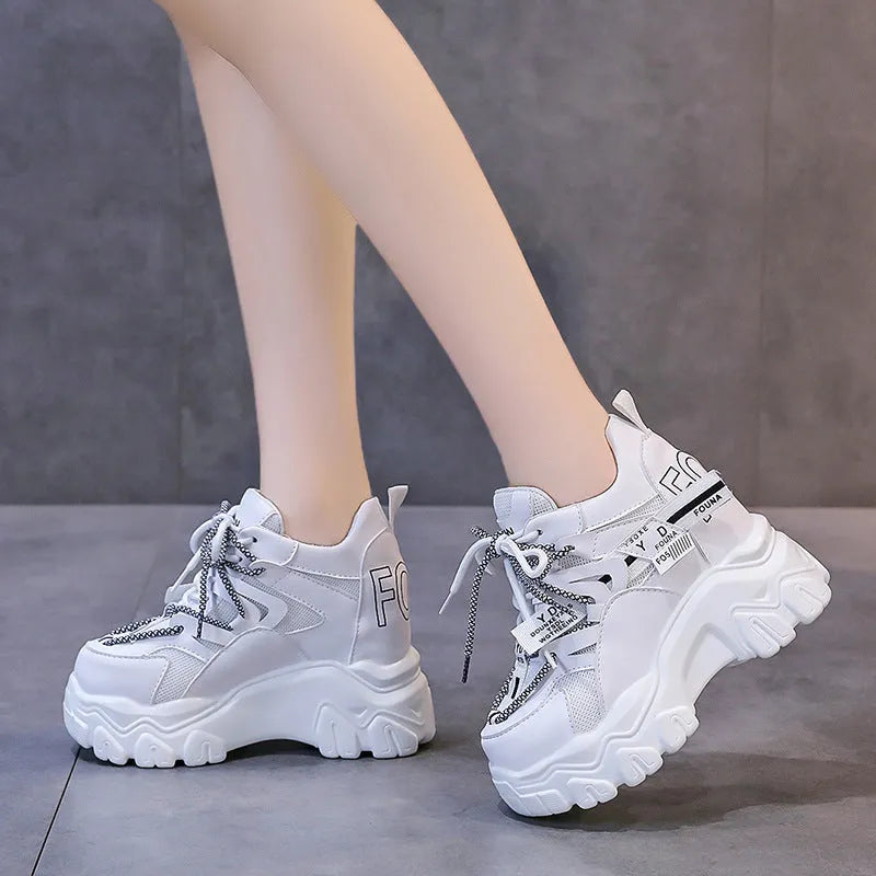Women's white and black mesh platform sports shoes with cross-strap design and rubber sole