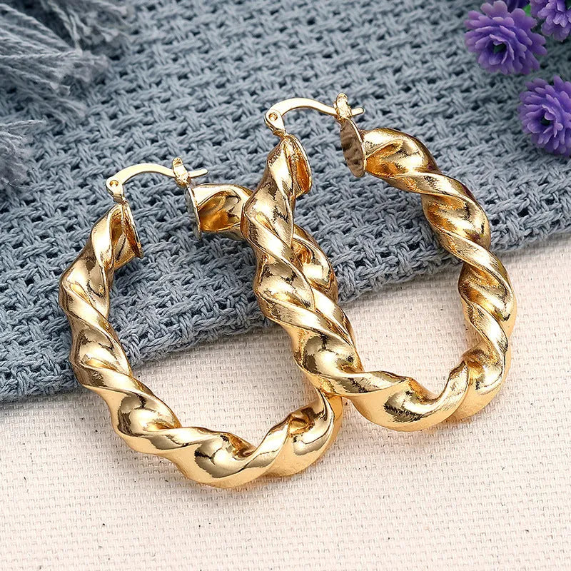 Women's geometric ring design copper clip-on earrings in electroplated colours on a white background.