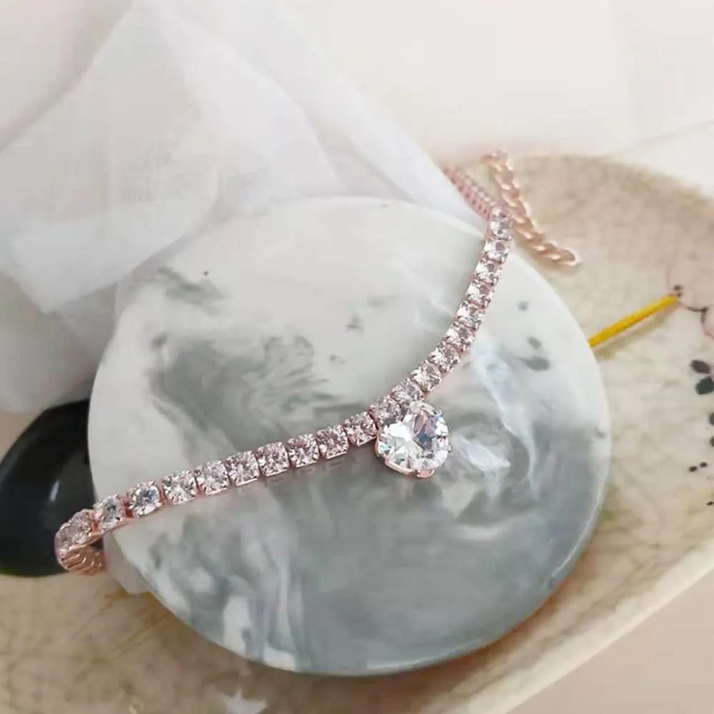 Gold rhinestone heart-shaped decorative collar for a dog with an extension chain.
