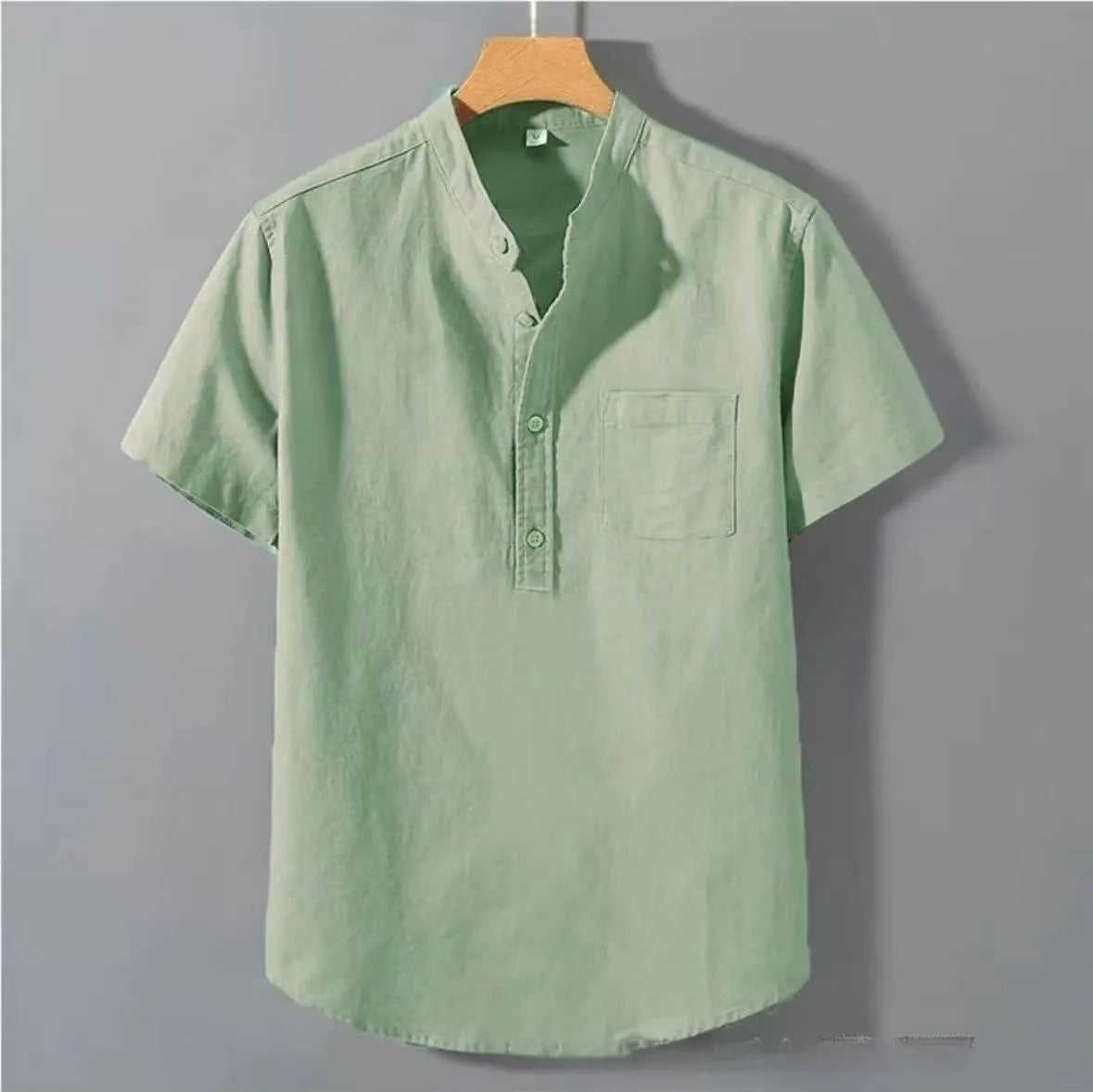 Men's beige slub linen casual shirt with stand collar and short sleeves on a hanger.