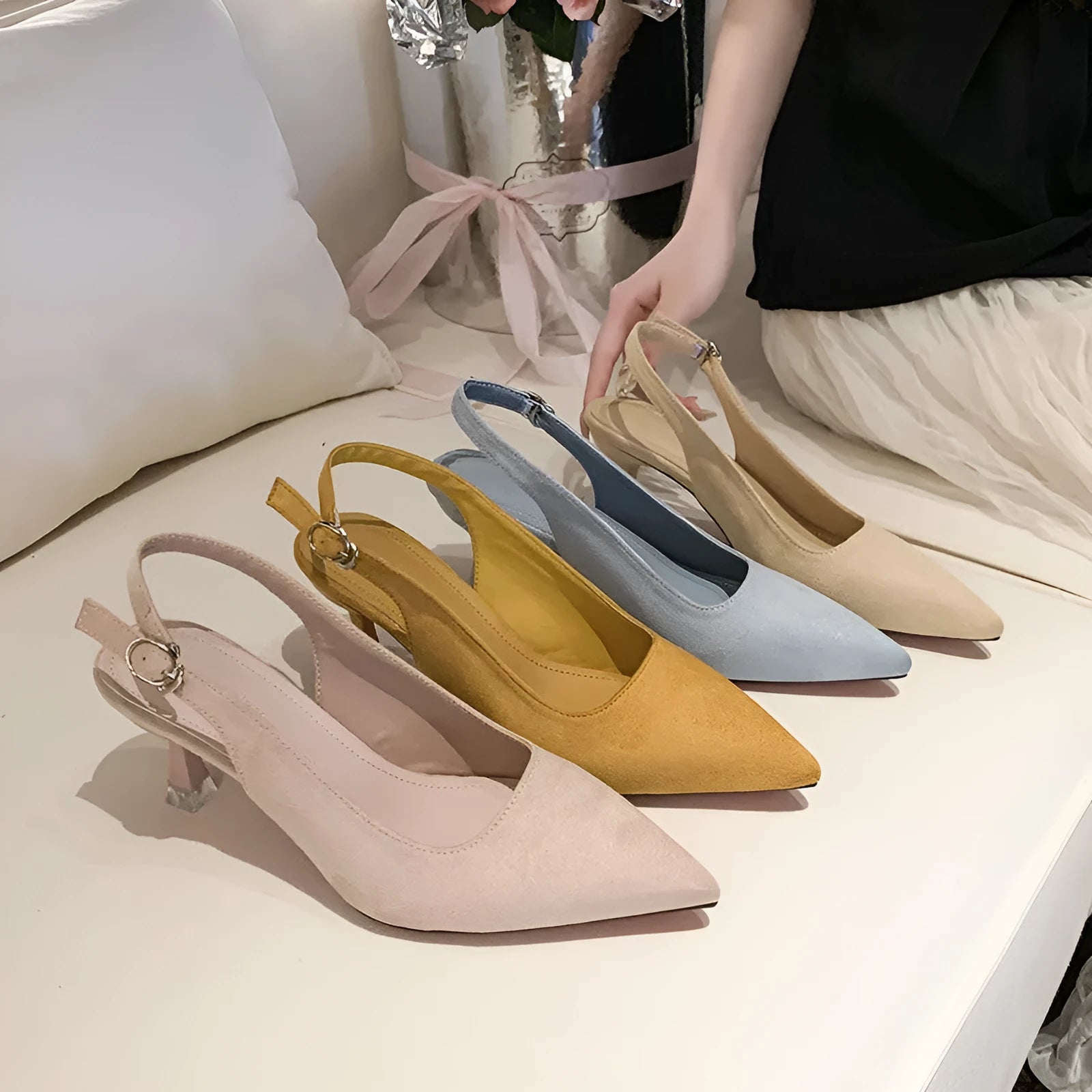 A pair of apricot suede pointed toe stiletto high heels with a rubber sole.