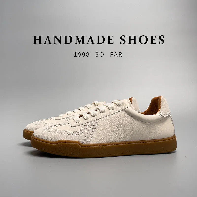 Men's beige genuine leather low-cut sneakers with white lace-up front and rubber sole on neutral background