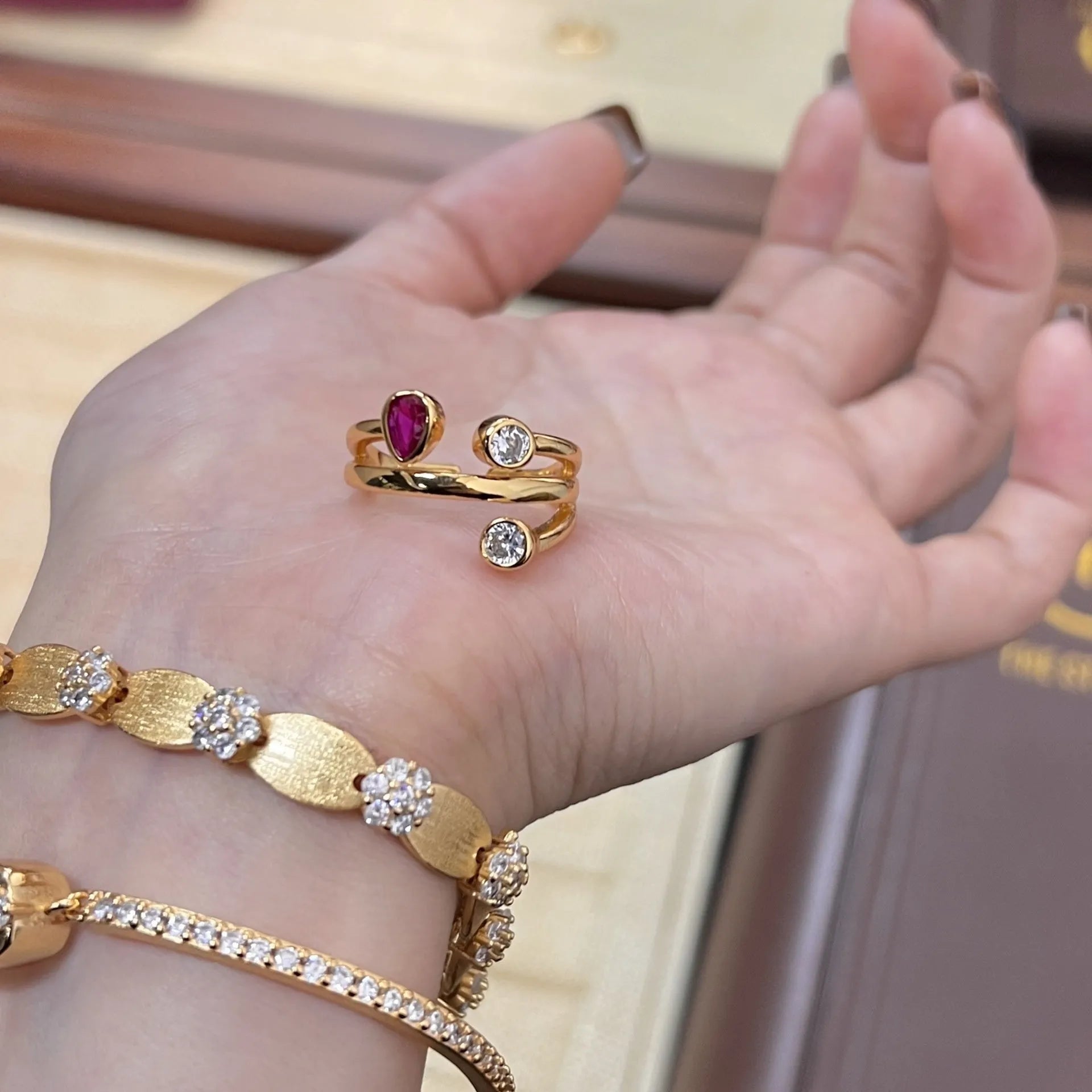 Copper geometric ring with irregular cross design and two-colour electroplated diamond decoration