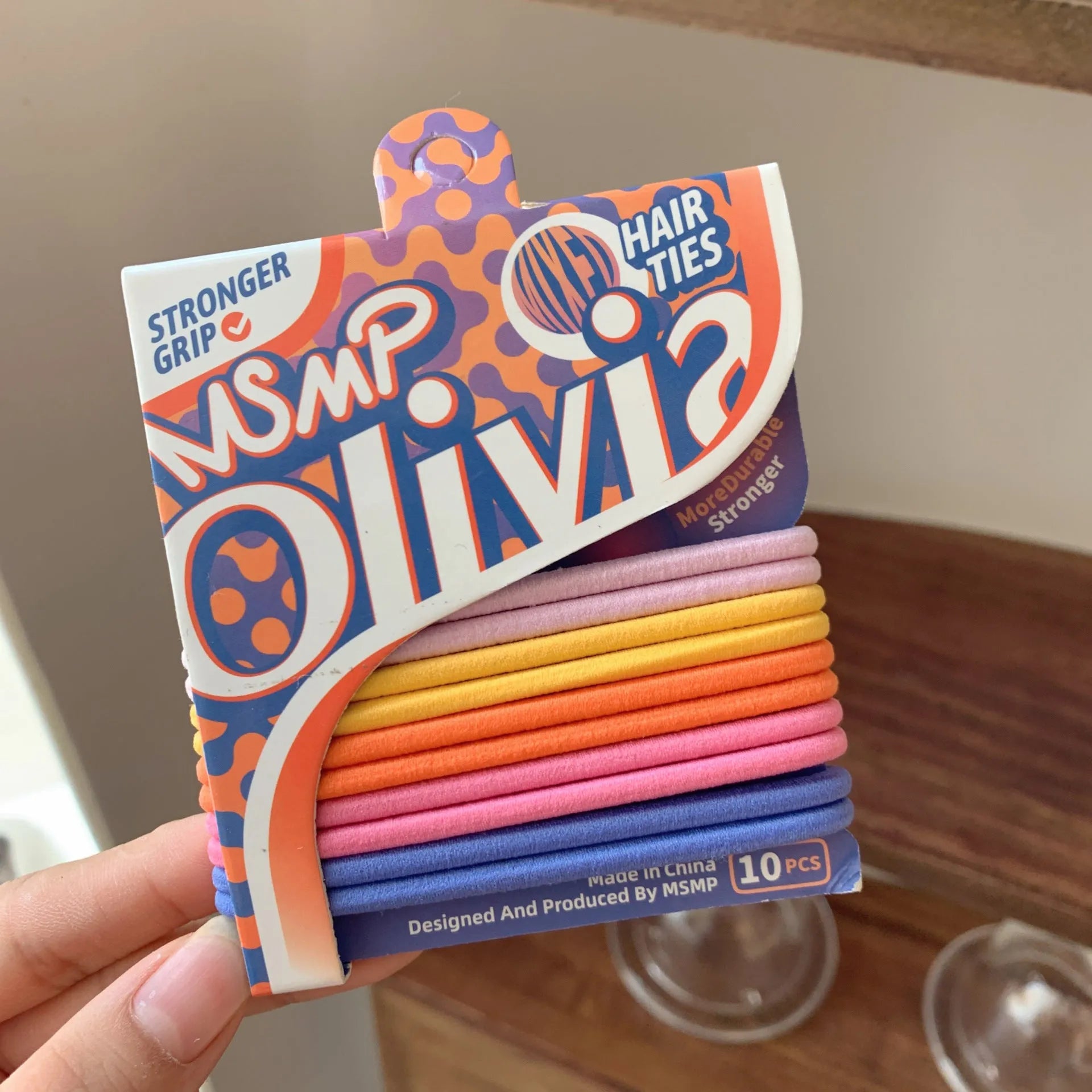 Set of candy coloured braided elastic hair bands laid flat