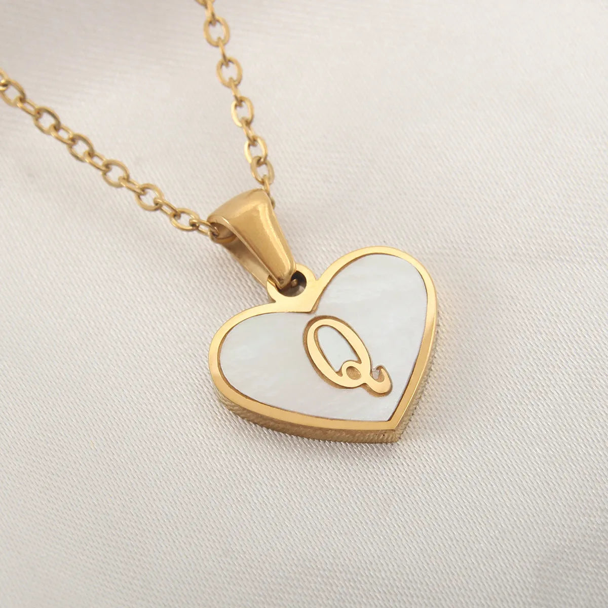 Gold heart necklace with white shell pendant and initial charm on 45cm adjustable chain