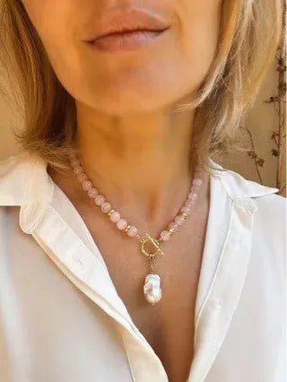 Women's handmade stainless steel pink crystal bracelet and necklace set, modern minimalist 10mm jewellery on a flat surface