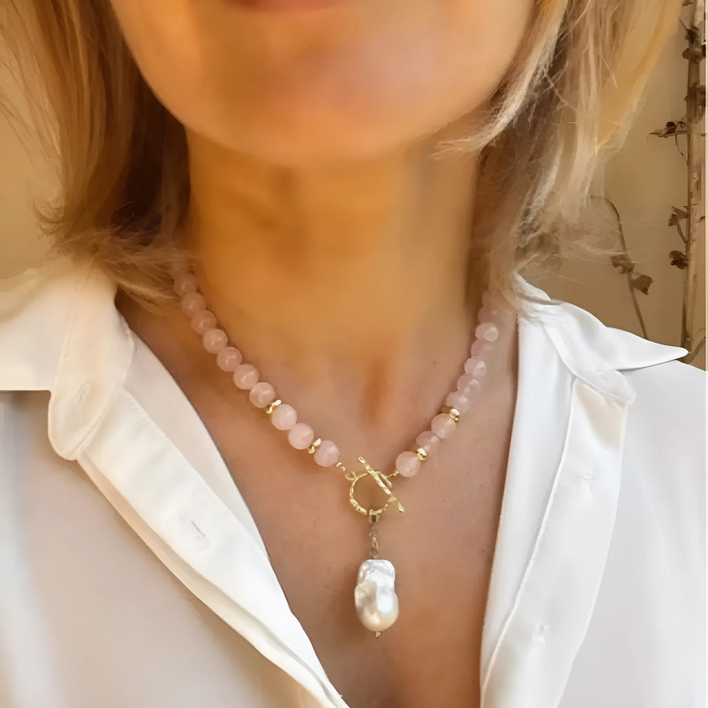 Women's handmade stainless steel pink crystal bracelet and necklace set, modern minimalist 10mm jewellery on a flat surface
