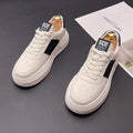 White unisex leisure shoes with cloth uppers and rubber foam soles in green or black accent colours